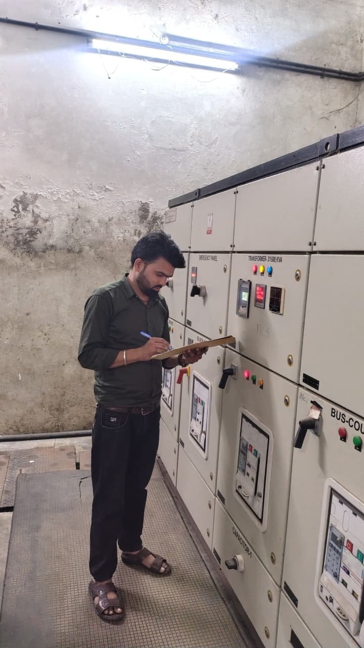 Technician documenting an electrical panel inspection